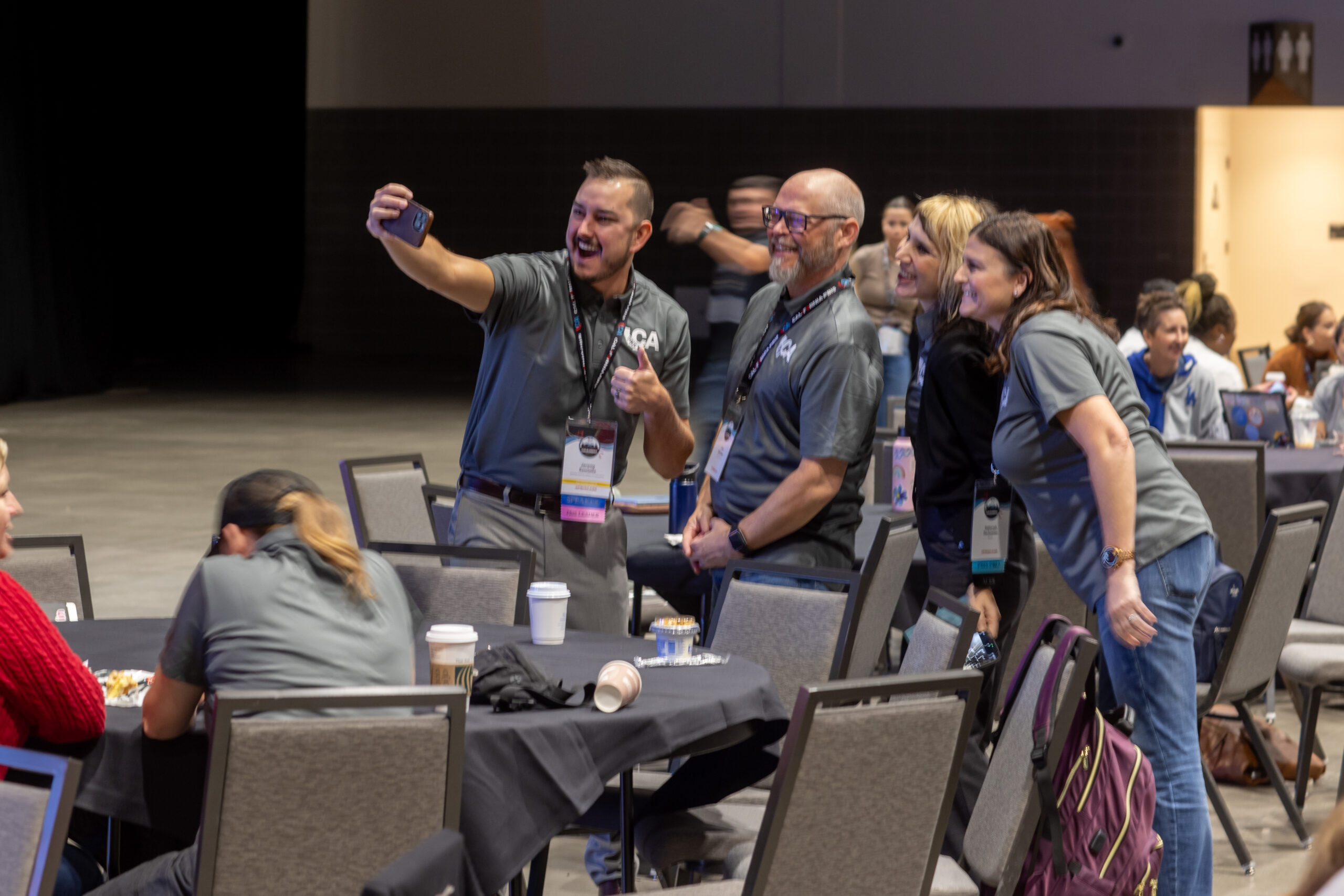 group of people stand and pose for a selfie together